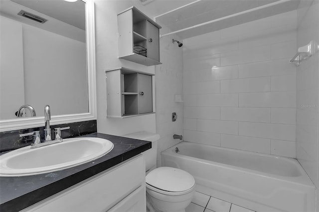 full bathroom featuring tile patterned flooring, vanity, tiled shower / bath combo, and toilet