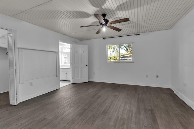 unfurnished bedroom featuring ceiling fan, dark wood-type flooring, and connected bathroom