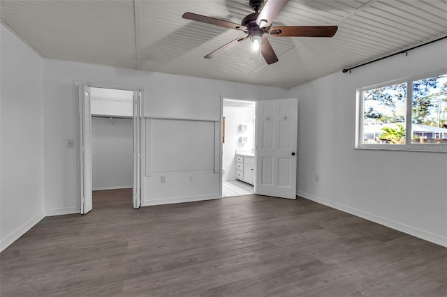 unfurnished bedroom with hardwood / wood-style floors, a closet, ceiling fan, and ensuite bathroom