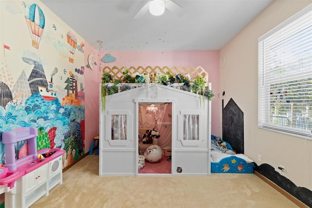 playroom with ceiling fan and light colored carpet