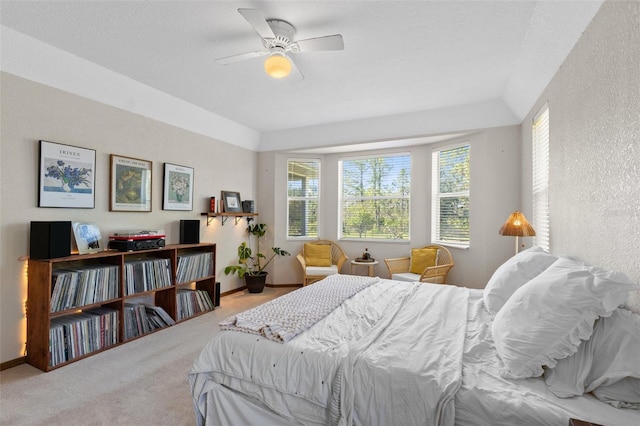 bedroom with light carpet, a textured ceiling, and ceiling fan