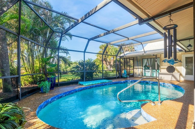 view of pool featuring a patio and glass enclosure