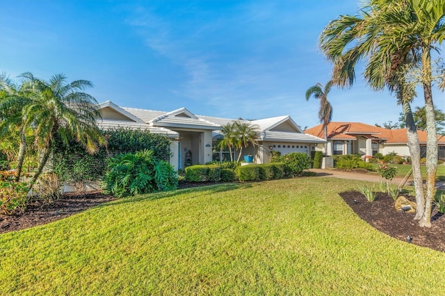 ranch-style home with a front yard and a garage