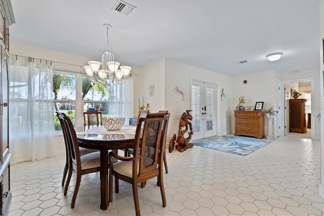 dining room featuring french doors and a notable chandelier