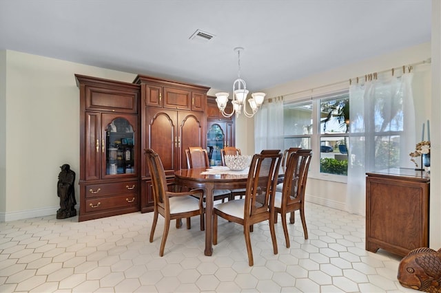 dining area featuring a notable chandelier