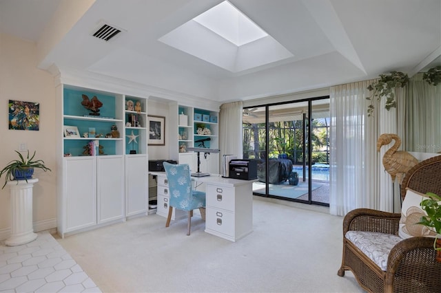 carpeted home office with a tray ceiling