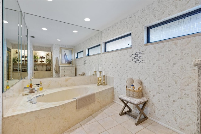 bathroom with tile patterned floors and tiled tub