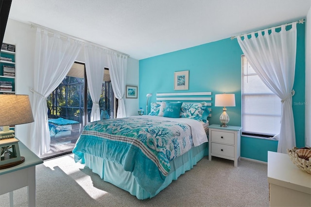 bedroom featuring light carpet and access to outside