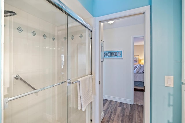 bathroom with wood-type flooring and walk in shower