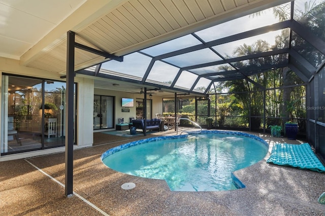 view of pool with a lanai, ceiling fan, and a patio area