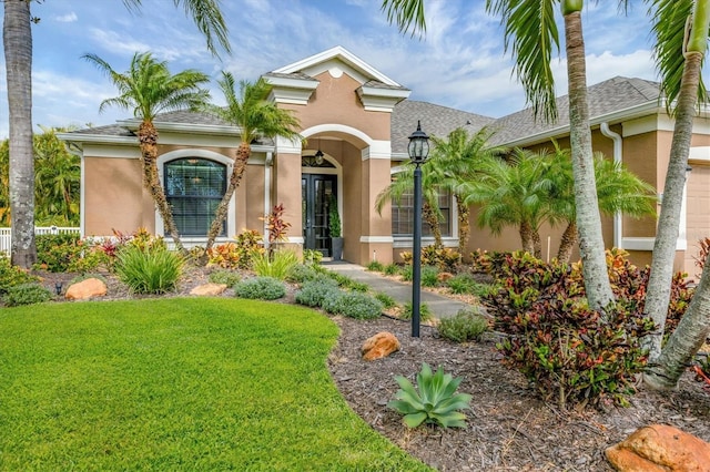 mediterranean / spanish home featuring a front lawn