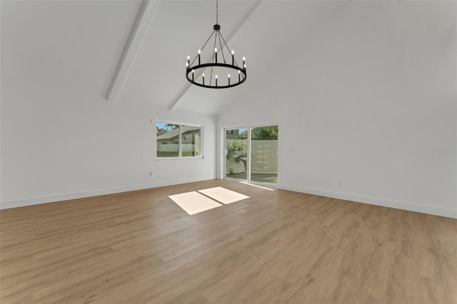 interior space featuring beam ceiling, light hardwood / wood-style floors, high vaulted ceiling, and a notable chandelier