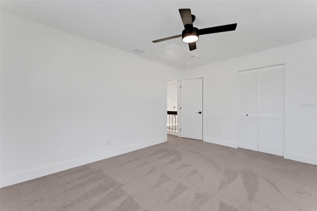 unfurnished bedroom featuring ceiling fan, a closet, and light carpet