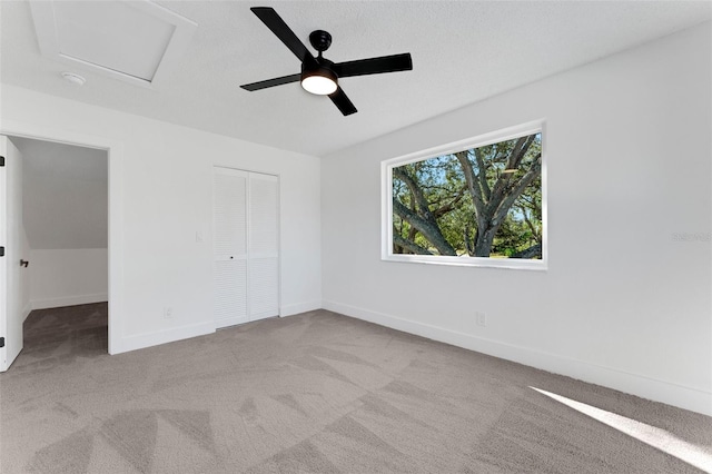 unfurnished bedroom featuring ceiling fan, a closet, and light carpet