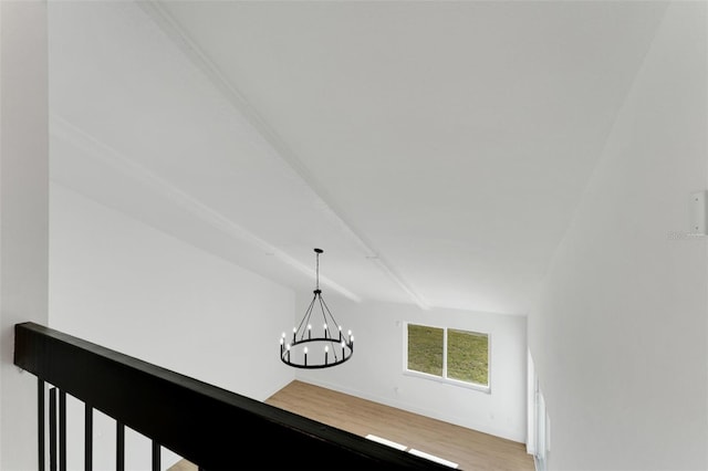 room details with wood-type flooring and an inviting chandelier