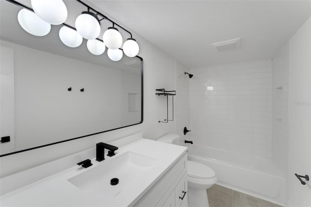 full bathroom with tile patterned flooring, vanity, toilet, and tiled shower / bath