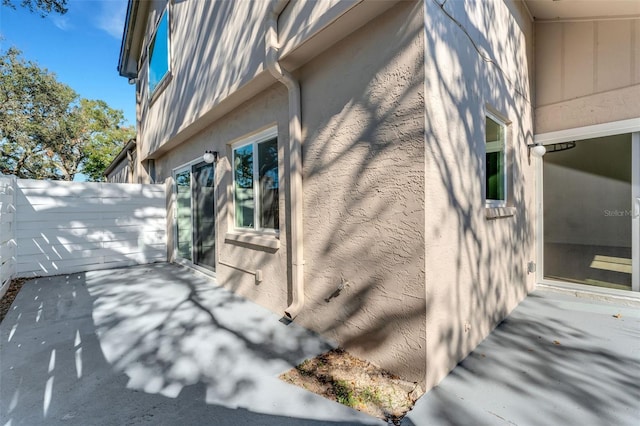 view of side of property featuring a patio area