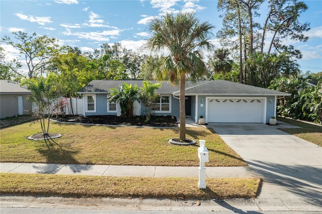 ranch-style home with a front yard and a garage