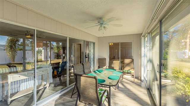 sunroom featuring ceiling fan