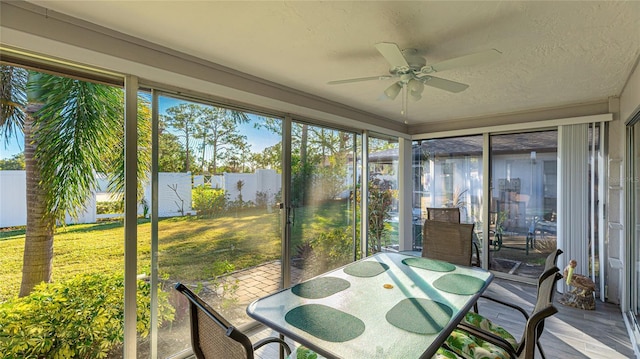 sunroom featuring ceiling fan