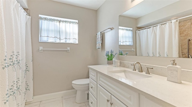 bathroom with tile patterned flooring, vanity, and toilet