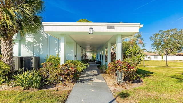 property entrance with a yard and central air condition unit