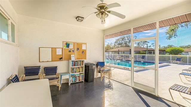 interior space with ceiling fan