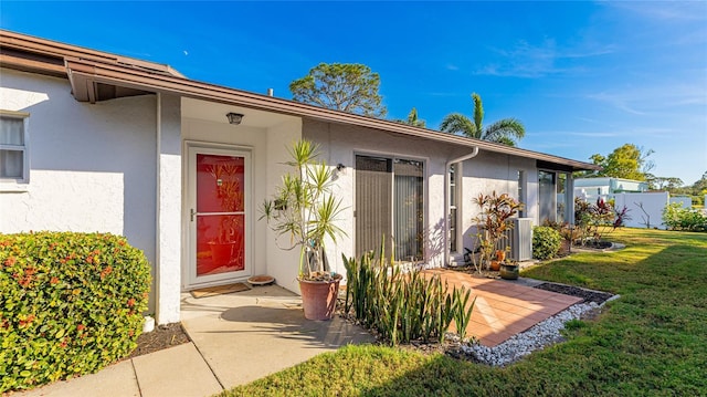 view of exterior entry featuring a yard