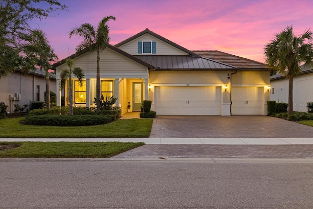 view of front of house featuring a lawn and a garage