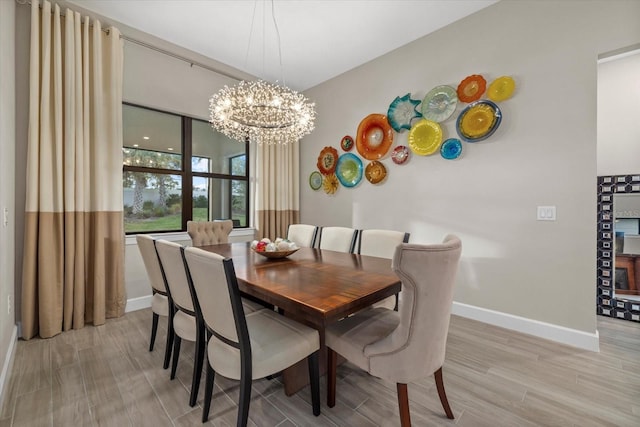 dining area featuring light hardwood / wood-style flooring and a notable chandelier