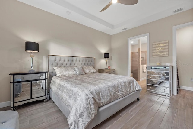 bedroom with light hardwood / wood-style floors, ensuite bath, and ceiling fan