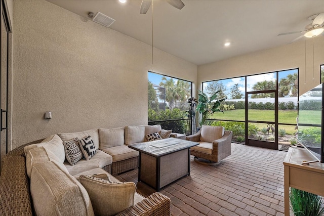 sunroom / solarium featuring ceiling fan