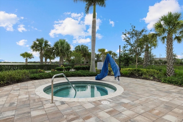 view of swimming pool featuring an in ground hot tub