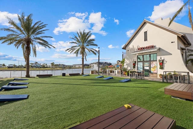 exterior space with a water view and a lawn