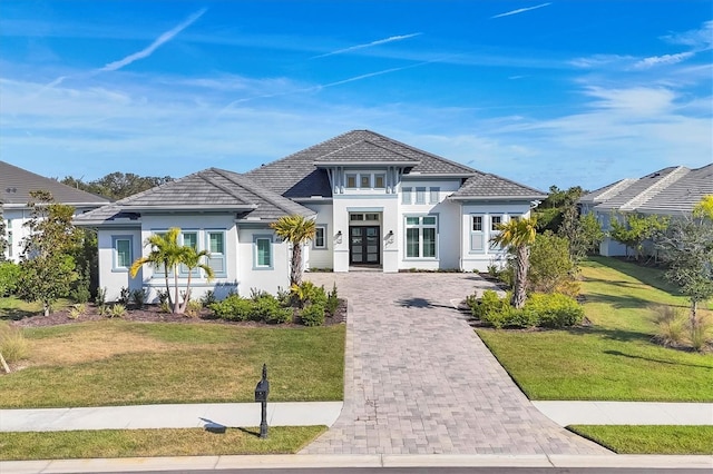 view of front of property featuring a front yard and french doors