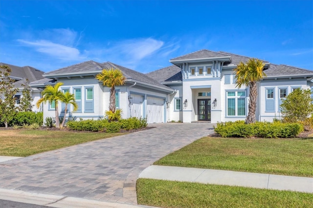 view of front of house with a garage and a front yard