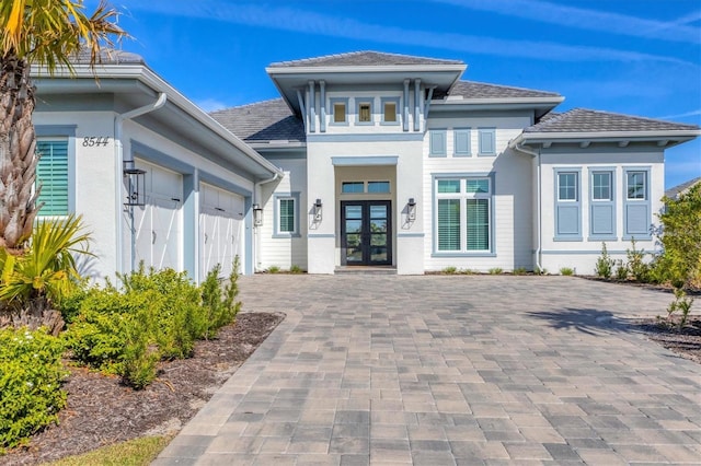 view of front facade featuring a garage and french doors