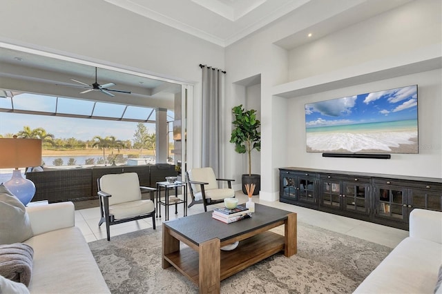 living room with a high ceiling, a water view, light tile patterned floors, and ceiling fan