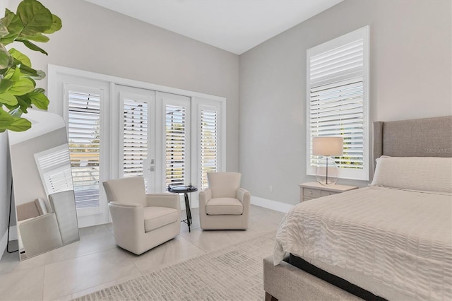 bedroom with light tile patterned floors and multiple windows