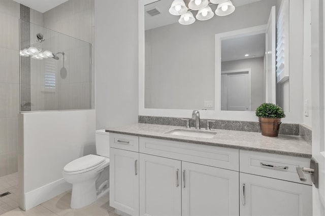 bathroom with tile patterned flooring, a tile shower, vanity, and toilet