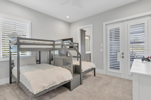 bedroom featuring access to exterior, ceiling fan, and light carpet