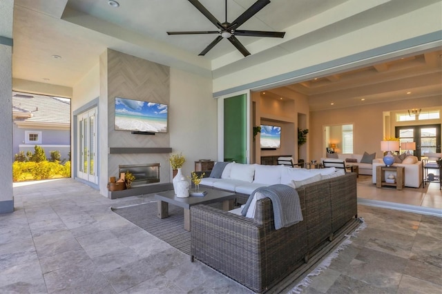 living room with ceiling fan and a fireplace