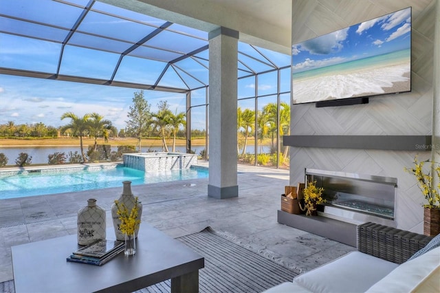 view of pool featuring glass enclosure, pool water feature, a patio area, an in ground hot tub, and a water view