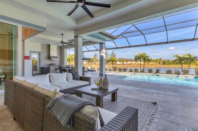 view of patio featuring an outdoor living space, a water view, and a lanai