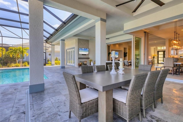 dining space featuring ceiling fan and exterior fireplace