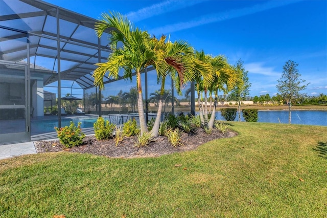 view of yard featuring a lanai and a water view