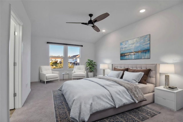 bedroom featuring light carpet, vaulted ceiling, and ceiling fan