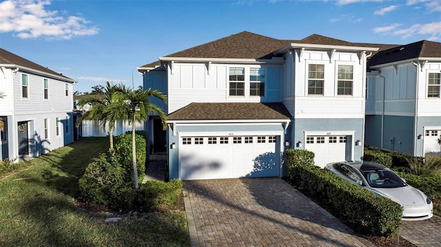 view of front of property featuring a garage and a front lawn