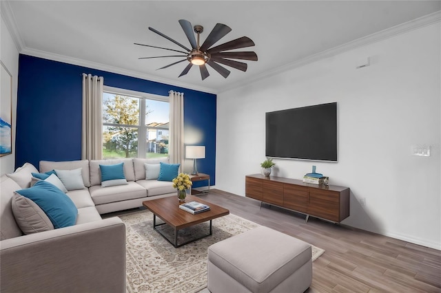 living room with crown molding, light hardwood / wood-style flooring, and ceiling fan