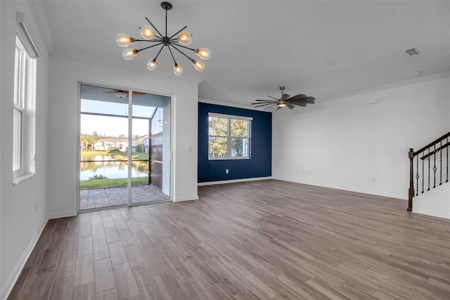 unfurnished living room featuring ceiling fan with notable chandelier, light hardwood / wood-style floors, a water view, and crown molding